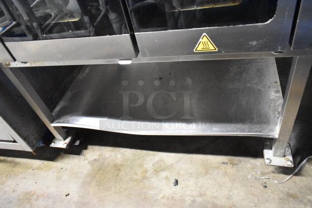 2020 Alto Shaam VMC-F4E stainless steel multi-cook oven on stand with casters; 208-240V, 1 Phase. Visible caution symbol.