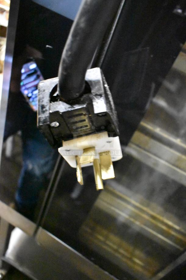 Close-up of a power plug for a 2020 Alto Shaam VMC-F4E commercial electric oven, indicating 208-240 volts, 1 phase.