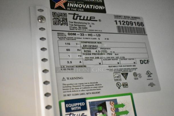Label for True GDM-33-HC-LD cooler; 115V, 1 phase, model details and warnings visible. Suitable for commercial use.