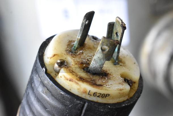 Close-up of L620P electrical plug with visible rust and wear, connected to Hobart P660 dough mixer, 208V, 1-phase.