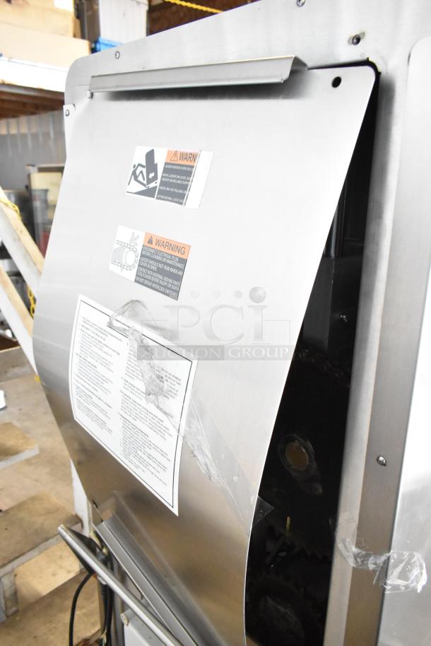 Stainless steel JBT 2ND-GEN-MFJ-HE citrus juicer, commercial floor style, on casters; 120V, 1 phase; warning labels visible.