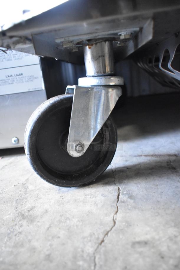 Toastmaster TCT-1627 R stainless steel tandoor oven caster, natural gas powered, commercial use. Visible caster detail.