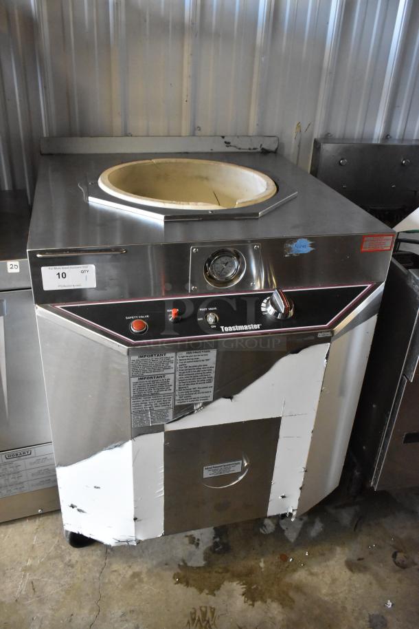 Toastmaster TCT-1627 R stainless steel natural gas tandoor oven, 85,500 BTU, on commercial casters, visible wear.