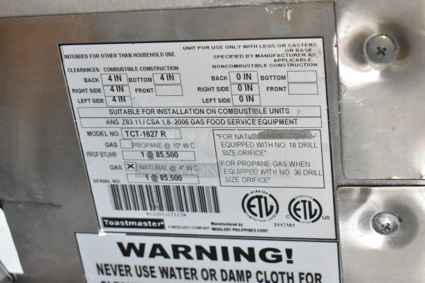 Toastmaster TCT-1627 R stainless steel commercial tandoor oven, 85,500 BTU, natural gas, on casters, installation and use labels visible.