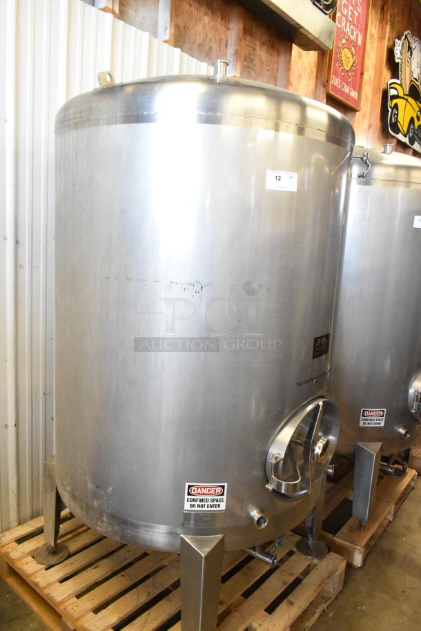 Stainless steel 10 BBL beer tank, 420-gallon capacity, commercial floor style. Features warning labels and sturdy base.