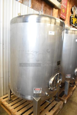 Stainless steel 10 BBL beer tank, 420-gallon capacity, commercial floor style. Features warning labels and sturdy base.