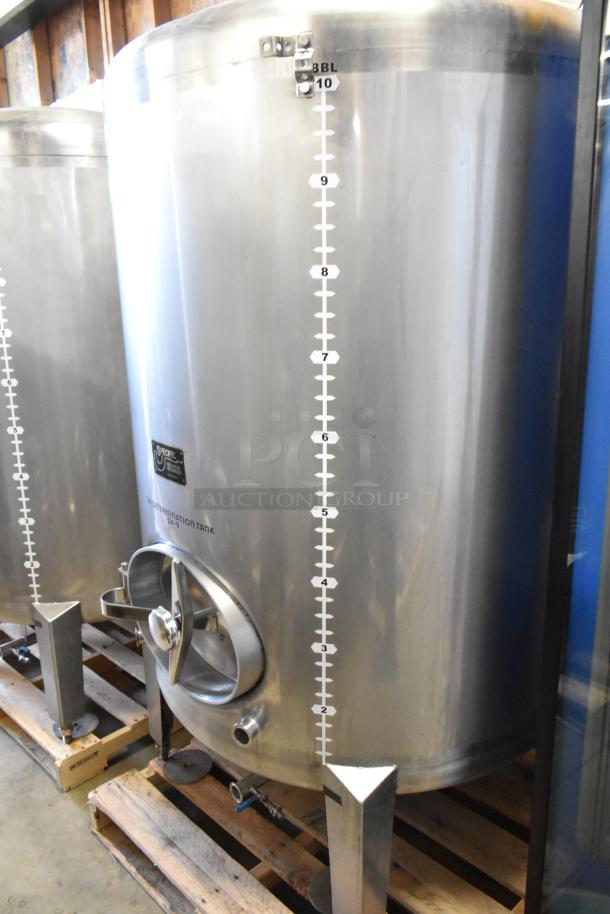 Stainless steel 10 BBL beer tax determination tank, clear beer tank, on pallet, with volume markings and access valve.