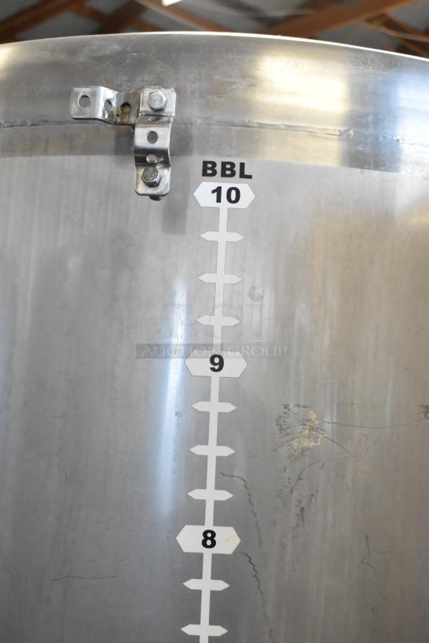 Stainless steel 10 BBL beer tank with volume markings, used for beer tax determination. Exhibits some surface wear.