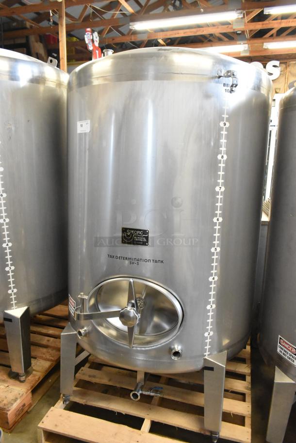 Stainless steel 10 BBL / 420 gallon beer tax determination tank, industrial-grade, with gauge markings and inspection hatch.