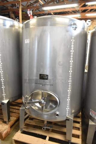 Stainless steel 10 BBL / 420 gallon beer tax determination tank, industrial-grade, with gauge markings and inspection hatch.
