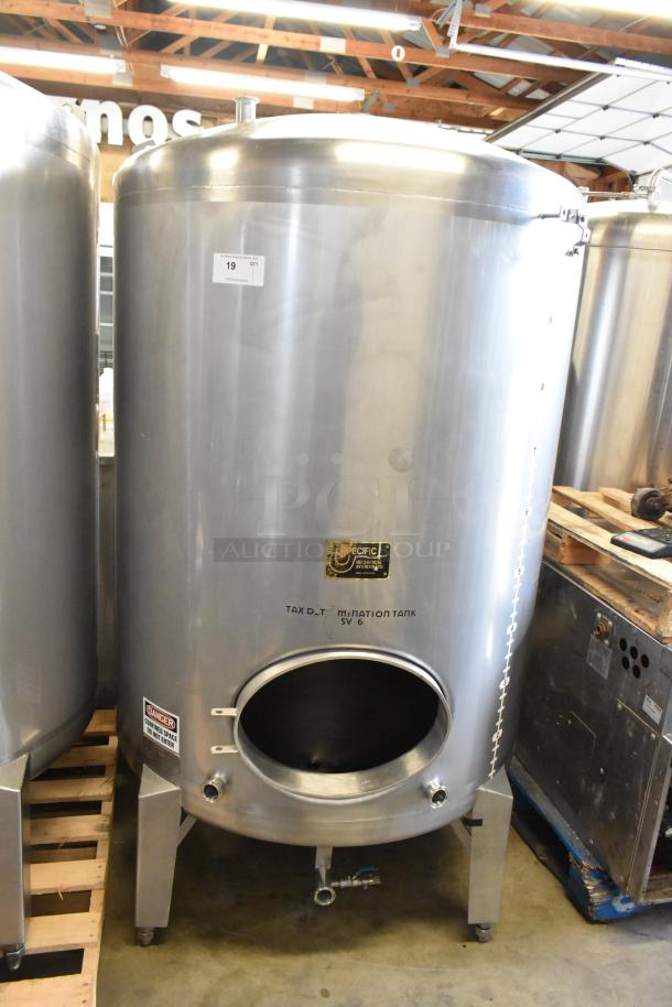 Stainless steel 10 BBL beer tax determination tank in used condition, with capacity markings and safety labels visible.