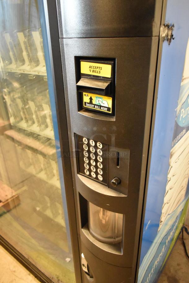 Metal commercial bottled drink vending machine, 115 volts, 1 phase. Features bill acceptor and keypad, good condition.