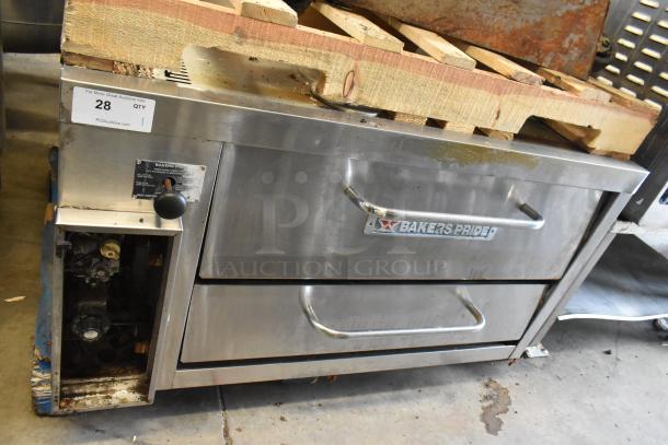 Bakers Pride stainless steel commercial single deck pizza oven with metal legs, commercial casters, and control panel.