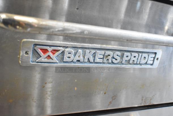 Bakers Pride stainless steel commercial pizza oven, single deck, with metal legs and commercial casters, used condition. Logos visible.