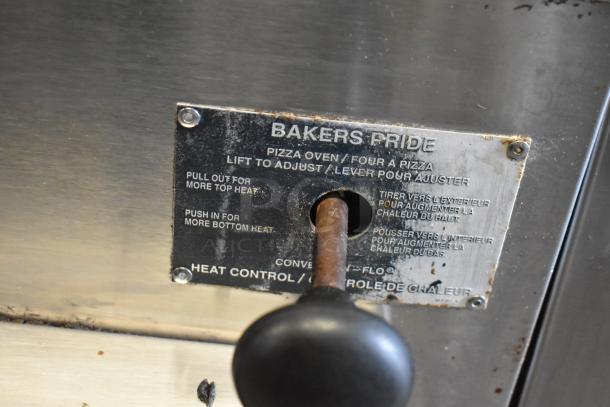 Bakers Pride stainless steel pizza oven heat control lever, adjustable for top and bottom heat settings, with usage wear.