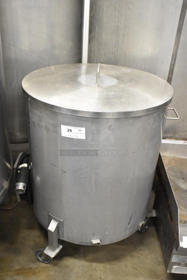 Metal commercial salad spinner on casters, silver finish, cylindrical design, visible wear, item label indicating "29 QTY".