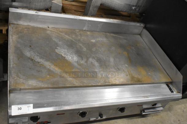 Southbend stainless steel countertop gas griddle, commercial use, visible wear on cooking surface, sturdy control knobs.