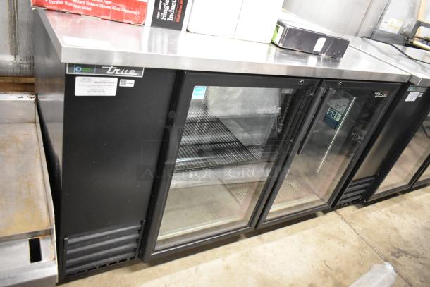 2023 True TBB-2G-HC-LD commercial 2-door back bar cooler, glass doors, black metal, 115V. Excellent condition.