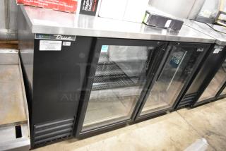 2023 True TBB-2G-HC-LD commercial 2-door back bar cooler, glass doors, black metal, 115V. Excellent condition.