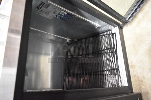2023 True TBB-2G-HC-LD metal commercial 2-door back bar cooler, glass shelves, visible label with voltage and model details.