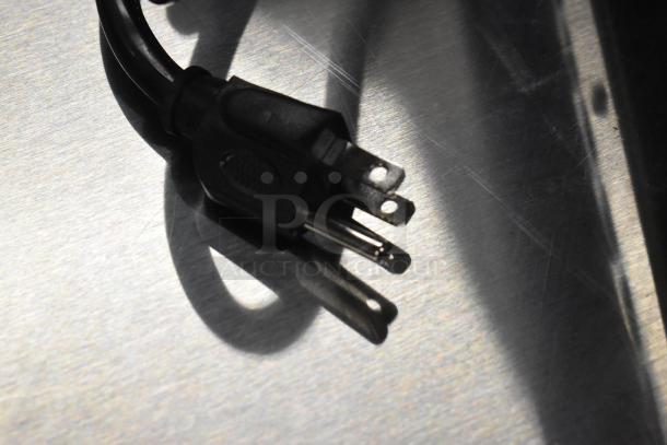 Close-up of a power plug for the Avantco 177IC1800 induction range, showcasing its new condition and sturdy build.