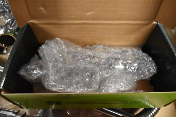 Brand new Regency 600PRA pre-rinse add-on faucet base in box, wrapped in bubble wrap for protection.