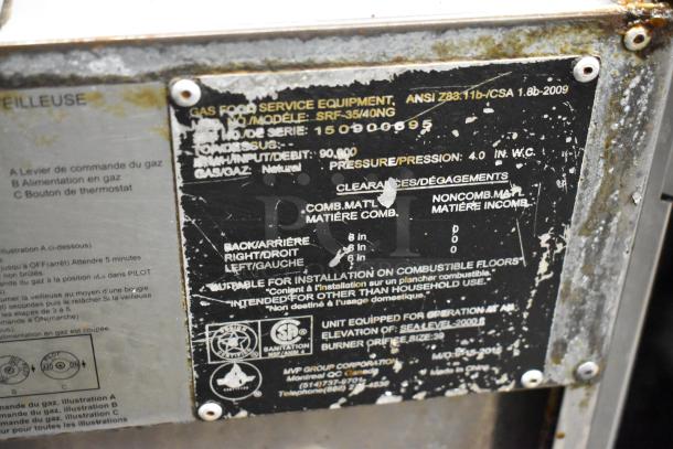 Sierra SRF-35/40NG stainless steel natural gas fryer, used, commercial casters, label shows specifications and safety info.