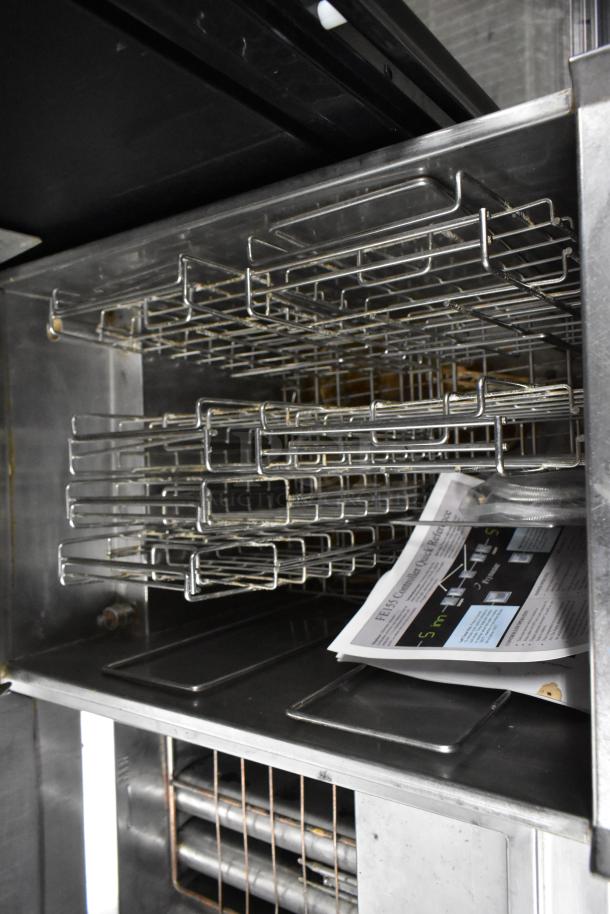 2016 Frymaster FE155CSE stainless steel rethermalizer, electric, on casters, open door view with racks and manual.