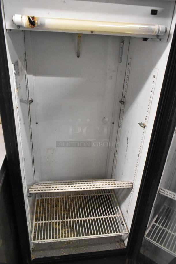 True GDM-12 commercial single door cooler merchandiser with poly-coated racks. Used condition, 115 volts, 1 phase.