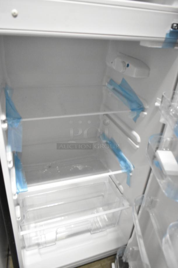 Frigidaire FGFR727 metal reach-in cooler with freezer, 115 volts, 1 phase, clean interior, adjustable shelves, new condition.