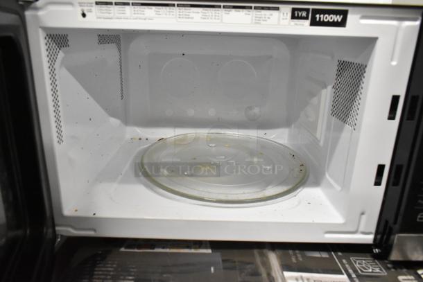 Frigidaire FFCM1155US microwave oven with glass plate. Minor interior usage marks. 120 volts, 1 phase, 1100W.