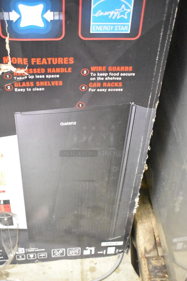 Brand new Galanz GLR33MBKE23 mini cooler in box. Features recessed handle, glass shelves, wire guards, and can racks. Energy Star rated. 115 volts, 1 phase.