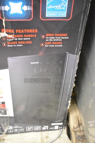 Brand new Galanz GLR33MBKE23 mini cooler in box. Features recessed handle, glass shelves, wire guards, and can racks. Energy Star rated. 115 volts, 1 phase.