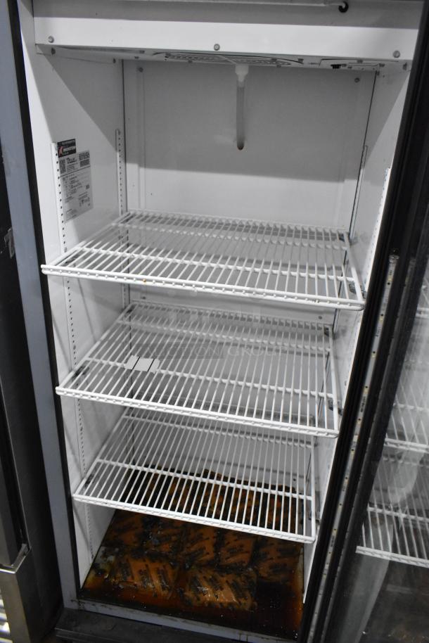 True GDM-12-HC-LD single door cooler with poly-coated racks, 115 Volts, showing interior shelves and condition.