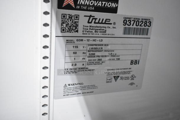 True GDM-12-HC-LD cooler label detailing model, voltage 115, phase 1, refrigerant R290. Serial number 9370283.