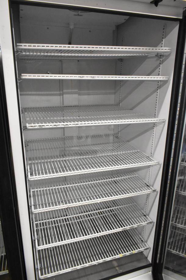 2021 True TSCI-600R-G-PH single door cooler merchandiser, metal, poly coated racks, excellent condition, 115V, 1 phase.