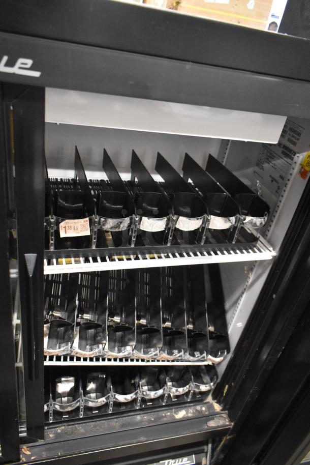 True GDM-41SL-48-HC-LD cooler, black metal, 2 doors, poly-coated racks, 115V, 1 Phase. Features pricing label inside.