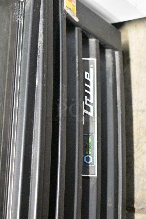 2017 True GDM-12-HC-LD cooler label, black metal frame, "True" logo visible. Poly coated racks, 115V, single-phase.