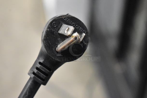 Close-up of a plug from a 2021 True TSCI-600R-G-PH Reach-In Cooler Merchandiser, 115 volts, 1 phase.