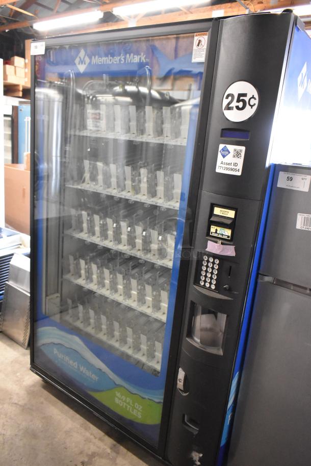 Metal commercial bottled drink vending machine by Member's Mark. Features include 115 volts, 1 phase, coin slot, and keypad.
