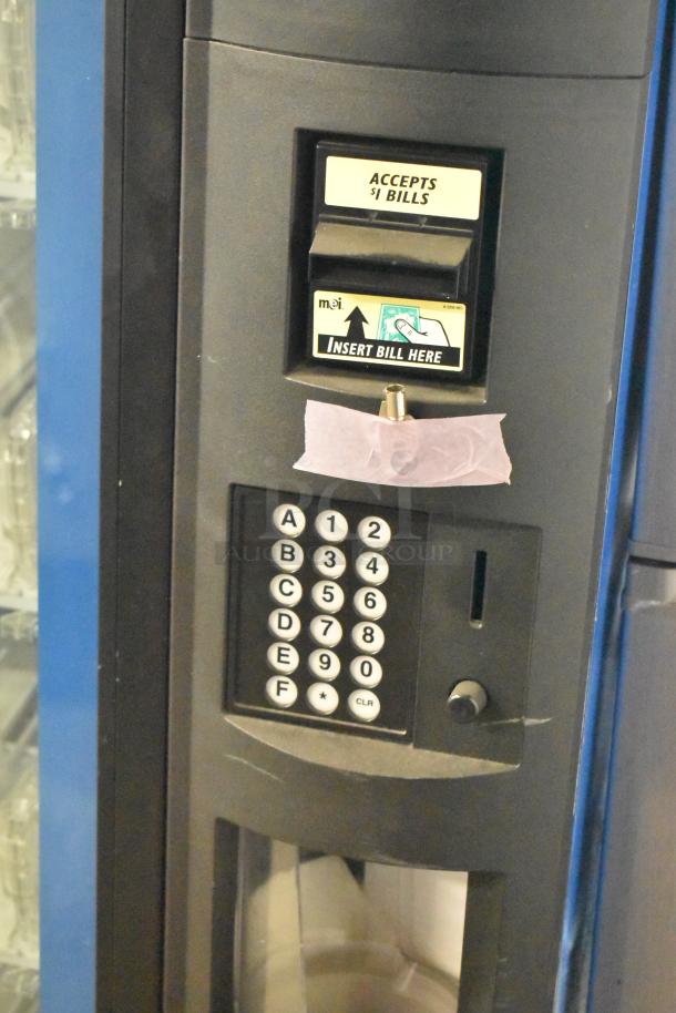 Metal commercial bottled drink vending machine, 115 volts, 1 phase. Features bill acceptor and keypad. Accepts $1 bills.