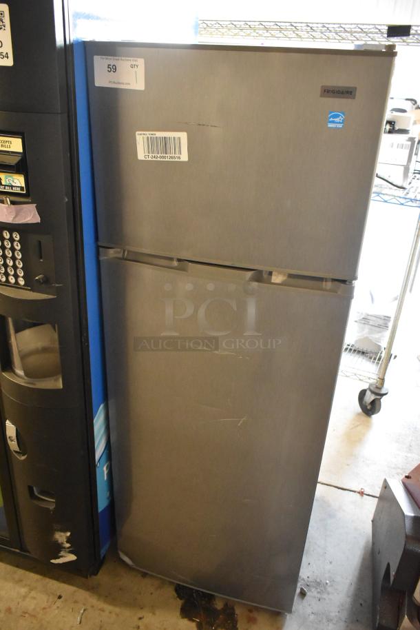 Frigidaire EFR780-T-6COM metal reach-in cooler with freezer, 115 volts, visible scratches, model tag shown.