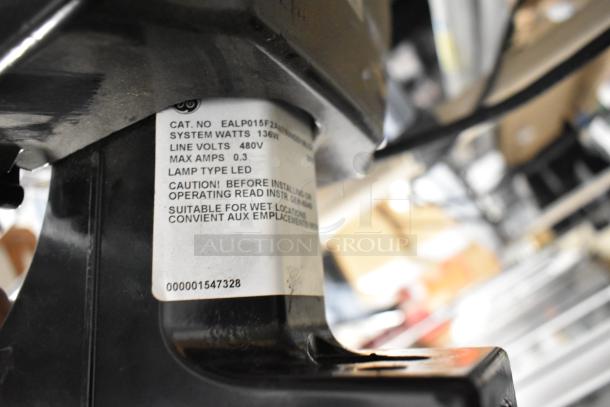 LED flood light label showing 136W, 480V, Cat. No. EALP015FZ, suitable for wet locations. Auction includes 4 units.