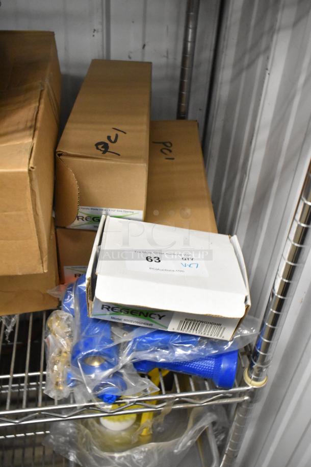 Boxes containing new Regency 600DT1 Twist Handle Waste Valves and spray handles, marked "PCI" on a metal shelf.