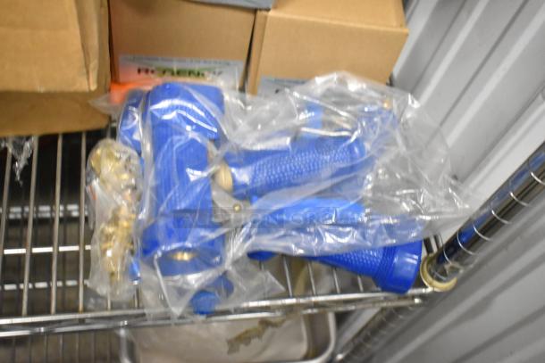7 brand new scratch and dent Regency waste valves and spray handles in packaging, shown on metal shelf.