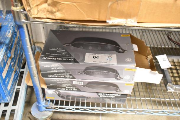 Three brand new American Metalcraft CIPOV9567 36 oz. pre-seasoned mini cast iron oval casserole dishes in retail boxes.