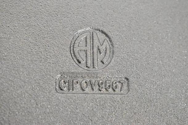 American Metalcraft CIPOV9567 mark on pre-seasoned cast iron casserole dish base, indicating model and brand.