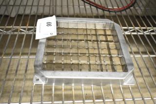 Brand new metal vegetable cutter blade, scratch and dent condition. Features wavy grid design, sturdy build, auction tag visible.