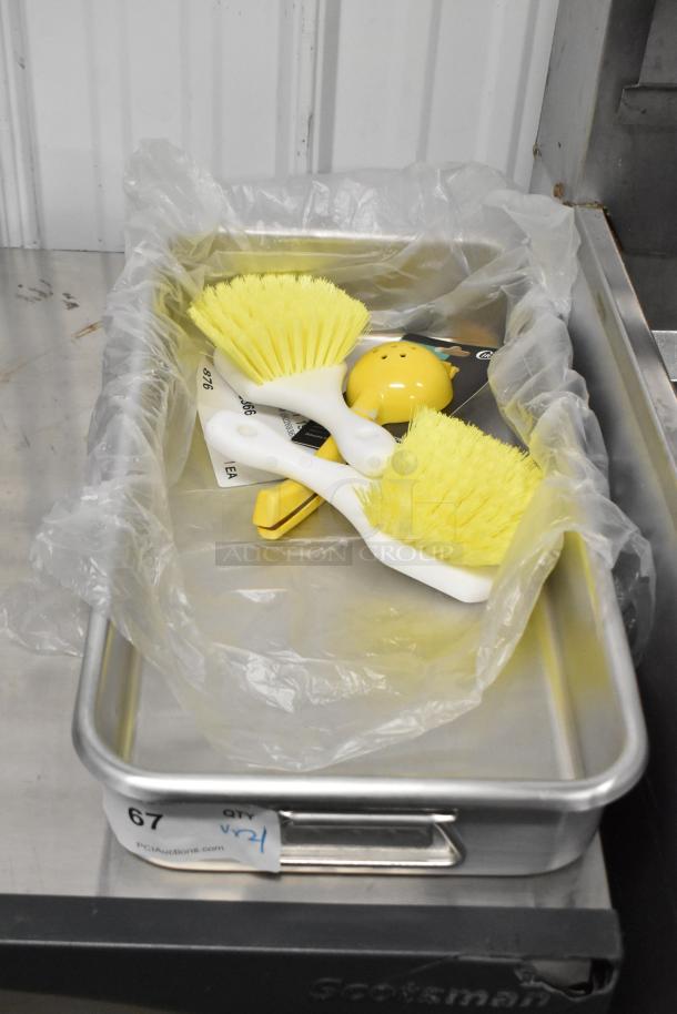 4 brand new items including 8" yellow aluminum lemon juicer, 11.25 qt. aluminum roasting pan, and brushes, in excellent condition.
