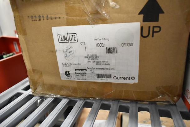Cardboard box labeled "Dual Lite DYN6I-WM Emergency Light." Features: IP66, 3W LED lamps, suitable for wet locations.